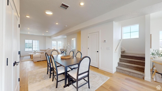 dining room with visible vents, recessed lighting, stairway, and light wood-style floors