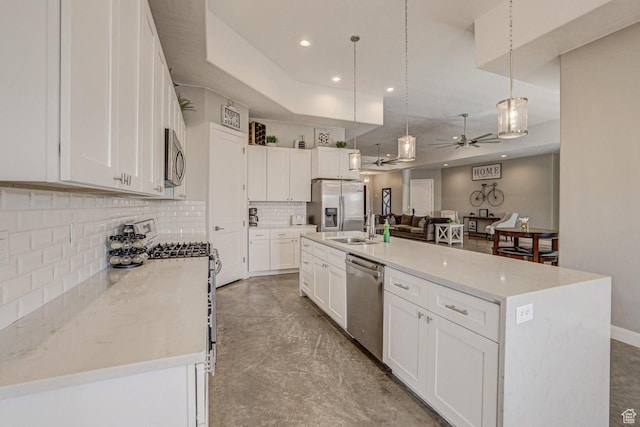 3243 S 4900 W, Hurricane, UT 84737 - kitchen featuring white cabinetry, stainless steel appliances, backsplash, hanging light fixtures, and a ceiling fan