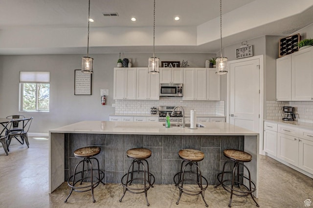 3243 S 4900 W, Hurricane, UT 84737 - kitchen featuring a kitchen island with sink, visible vents, white cabinets, and stainless steel appliances