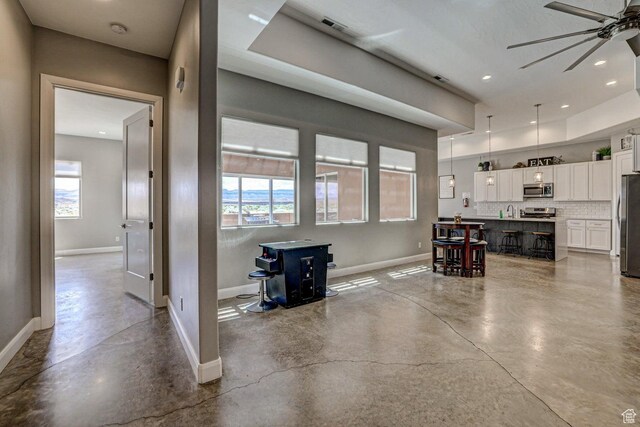 3243 S 4900 W, Hurricane, UT 84737 - living area with recessed lighting, a wood stove, concrete floors, baseboards, and ceiling fan