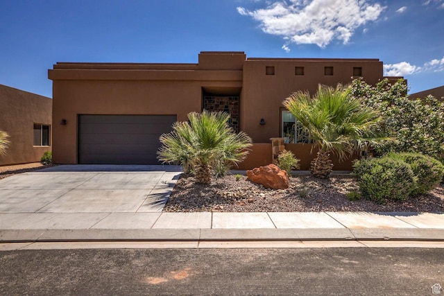 3243 S 4900 W, Hurricane, UT 84737 - pueblo-style home with driveway, a garage, and stucco siding