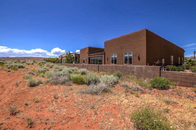 3243 S 4900 W, Hurricane, UT 84737 - rear view of house with stucco siding and fence