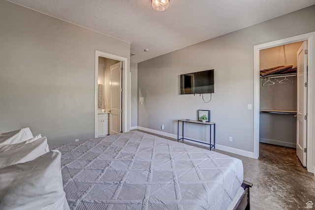 3243 S 4900 W, Hurricane, UT 84737 - bedroom with baseboards, ensuite bath, concrete flooring, and a walk in closet