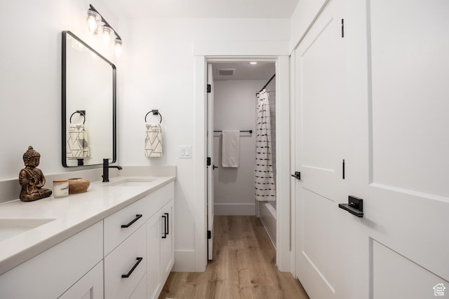 608 E Simpson Ave S, Salt Lake City, UT 84106 - full bathroom featuring double vanity, baseboards, visible vents, wood finished floors, and a sink