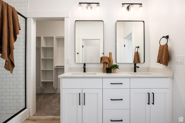 608 E Simpson Ave S, Salt Lake City, UT 84106 - full bathroom with a stall shower, a sink, a spacious closet, and double vanity