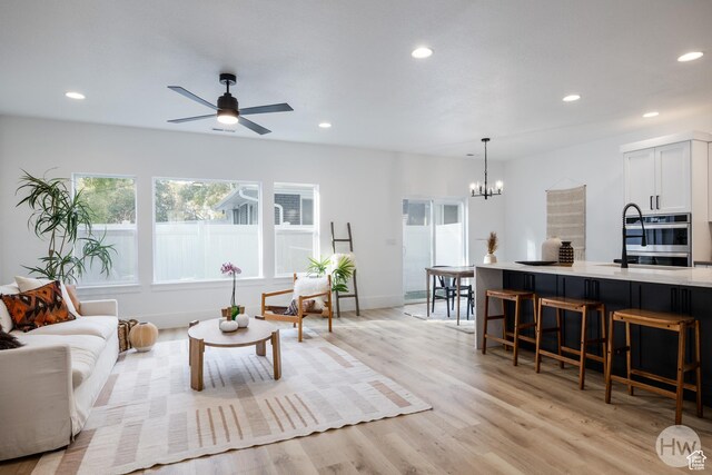 608 E Simpson Ave S, Salt Lake City, UT 84106 - living area with ceiling fan with notable chandelier, light wood-type flooring, baseboards, and recessed lighting