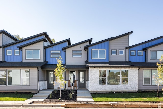 608 E Simpson Ave S, Salt Lake City, UT 84106 - view of front of home with board and batten siding, stone siding, and roof with shingles