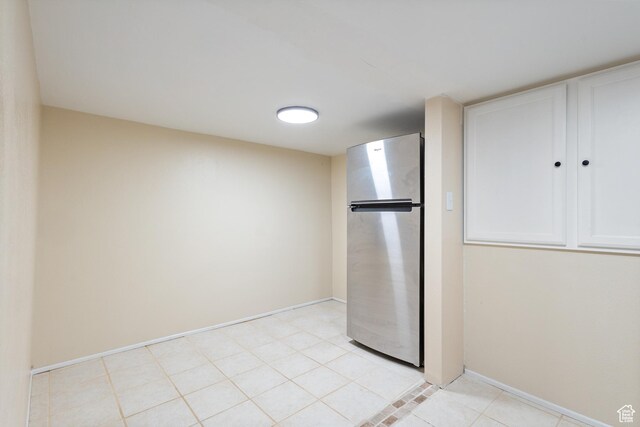 331 W 200 N, Delta, UT 84624 - kitchen with light tile patterned floors, baseboards, white cabinets, and freestanding refrigerator