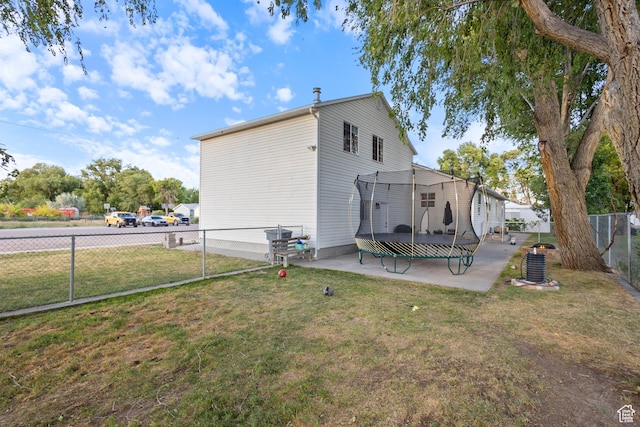 331 W 200 N, Delta, UT 84624 - back of property with a lawn, a trampoline, a fenced backyard, and a patio area