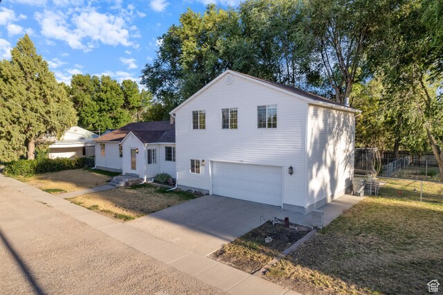 331 W 200 N, Delta, UT 84624 - view of front of house featuring driveway, a front yard, an attached garage, and fence