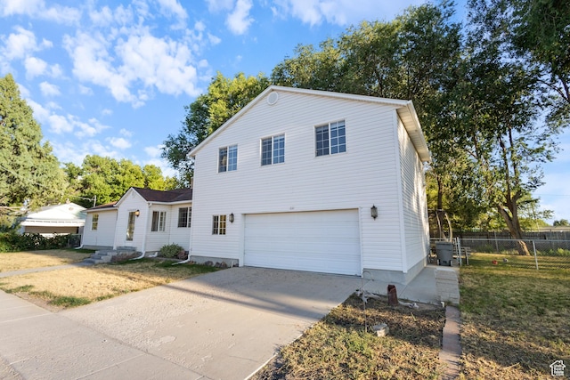 331 W 200 N, Delta, UT 84624 - traditional-style house with a front yard, concrete driveway, a garage, and fence