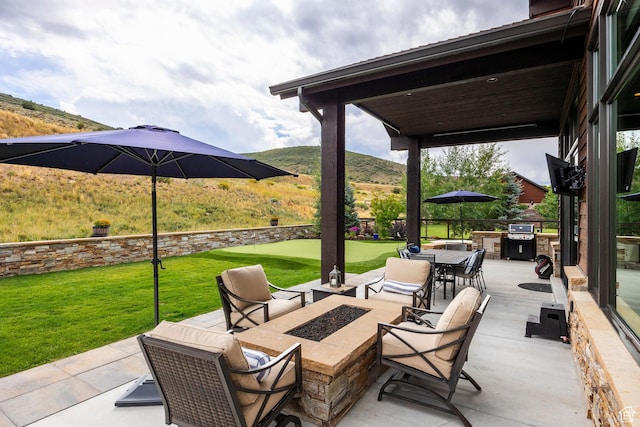 view of patio / terrace featuring a grill and an outdoor fire pit