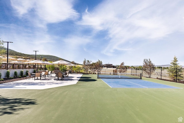 view of sport court featuring fence