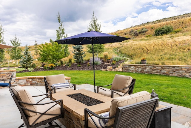 view of patio / terrace featuring an outdoor living space with a fire pit