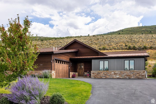 626 Thorn Creek Dr, Kamas, UT 84036 - view of front facade featuring stone siding, an attached garage, a standing seam roof, a metal roof, and asphalt driveway