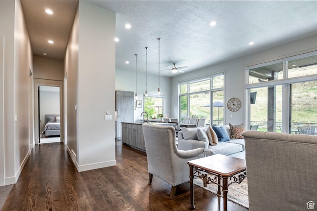 living room featuring recessed lighting, a textured ceiling, ceiling fan, and dark wood finished floors