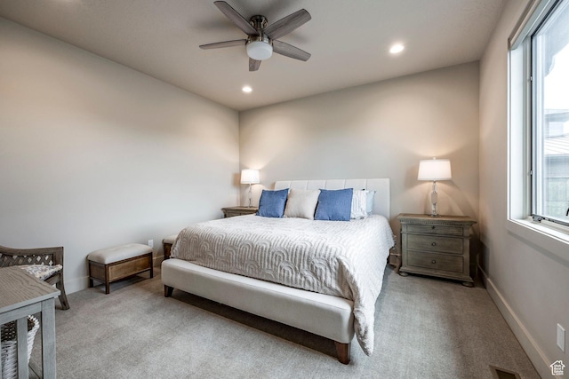 carpeted bedroom featuring baseboards, recessed lighting, and multiple windows