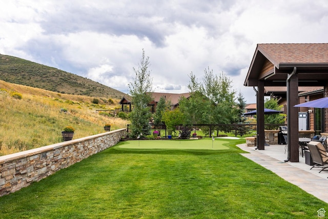 view of yard featuring a patio area and a mountain view