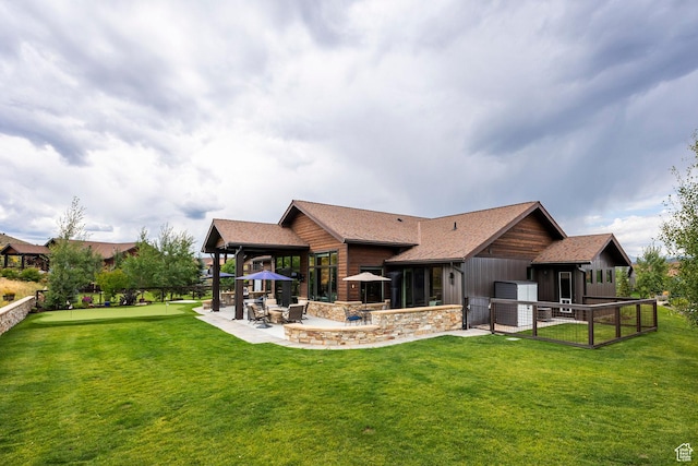 rear view of house with a yard, a patio, and fence