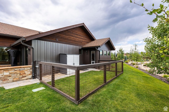 back of property with a lawn