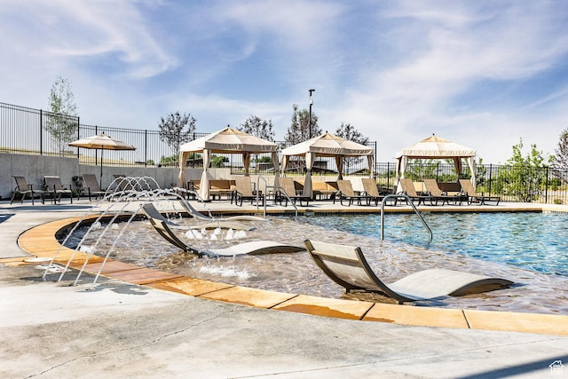 community pool featuring a gazebo and fence