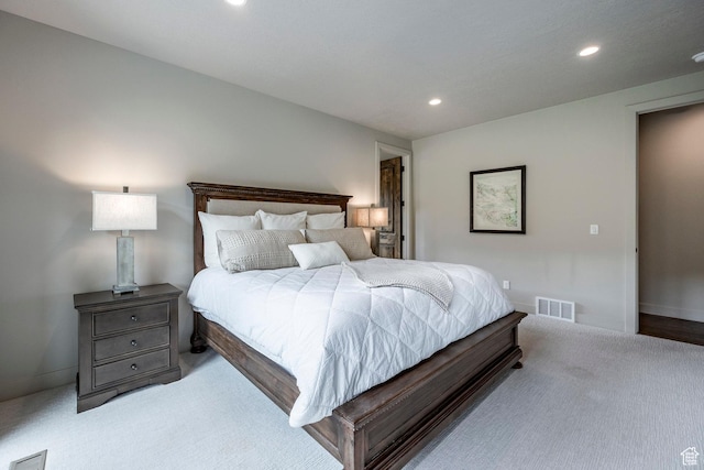 carpeted bedroom with recessed lighting, visible vents, and baseboards
