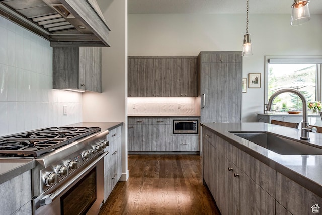 kitchen with tasteful backsplash, stainless steel range, custom exhaust hood, and a sink