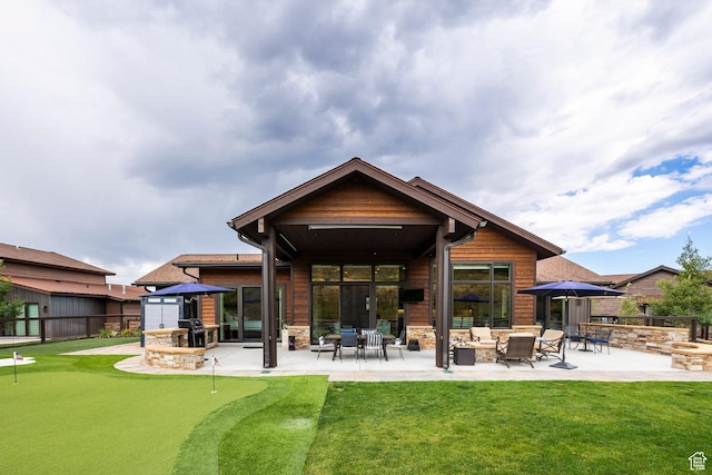 626 Thorn Creek Dr, Kamas, UT 84036 - rear view of property featuring a putting green, a patio, stone siding, and an outdoor living space with a fire pit
