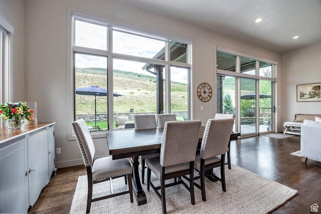 dining space featuring dark wood-style flooring, recessed lighting, and a healthy amount of sunlight