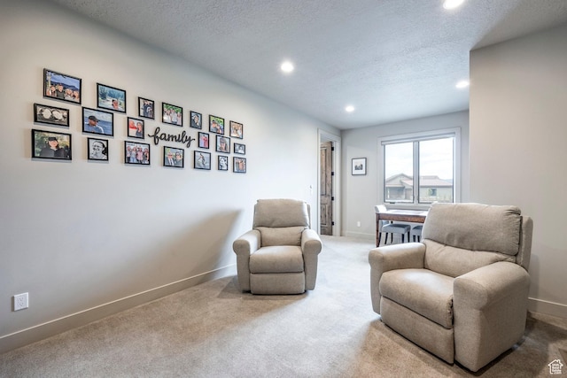 sitting room featuring recessed lighting, a textured ceiling, and baseboards