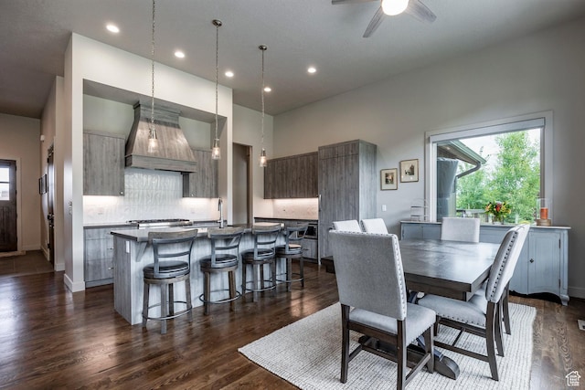 dining area featuring recessed lighting, baseboards, a wealth of natural light, and dark wood-type flooring