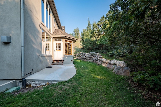 view of yard featuring entry steps and a patio