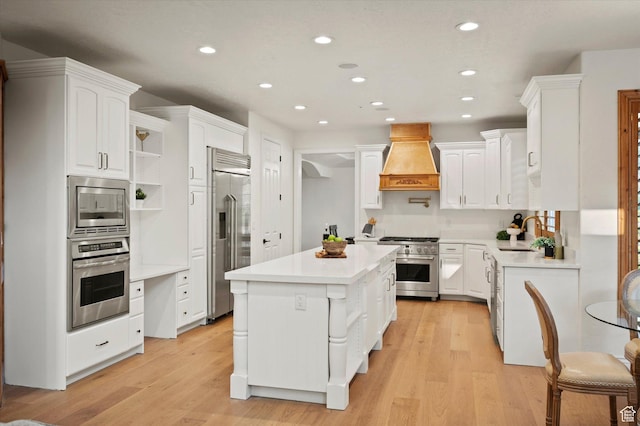 kitchen featuring a sink, built in appliances, a center island, custom exhaust hood, and white cabinets