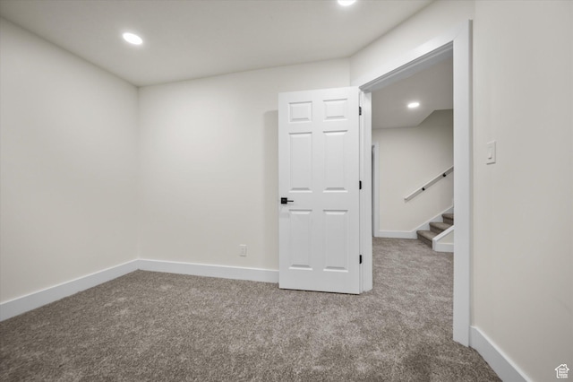 carpeted empty room with baseboards, stairway, and recessed lighting