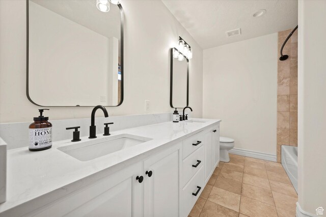 full bath with double vanity, visible vents, toilet, and a sink