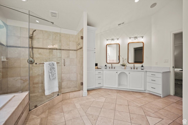 bathroom with a stall shower, visible vents, tile patterned flooring, and a sink
