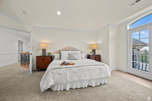 carpeted bedroom featuring ornamental molding, baseboards, access to exterior, and visible vents