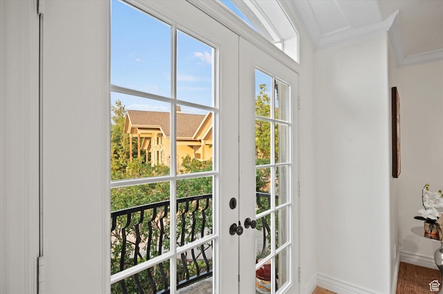 doorway with baseboards, ornamental molding, and french doors