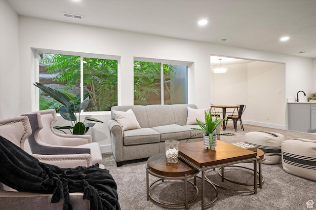 living room featuring baseboards, visible vents, carpet floors, and recessed lighting