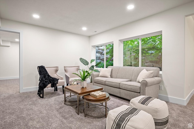 carpeted living area featuring visible vents, baseboards, and recessed lighting