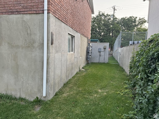 1775 N Railroad St W, Lehi, UT 84043 - view of side of property featuring stucco siding, fence, and a lawn