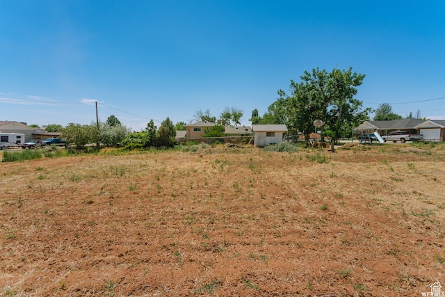 view of yard with a shed and an outbuilding