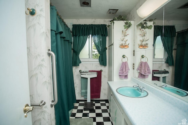 bathroom featuring visible vents, vanity, and tile patterned floors