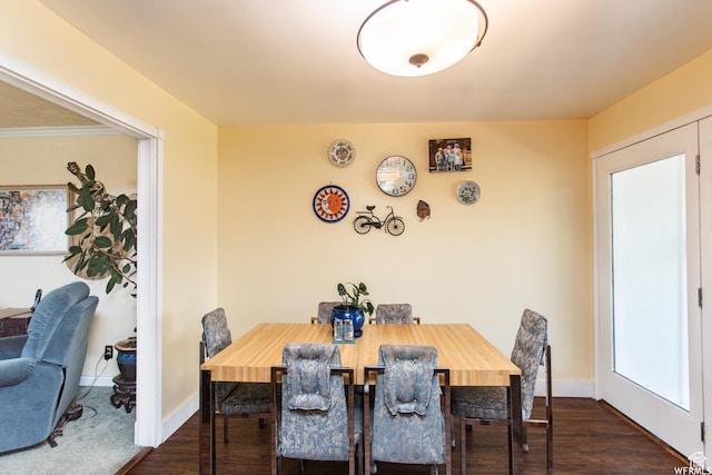 dining room with dark wood-type flooring and baseboards