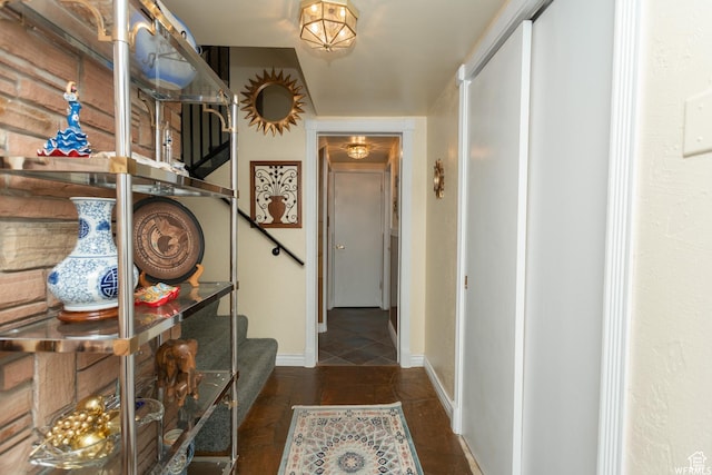 doorway to outside with stairway and baseboards