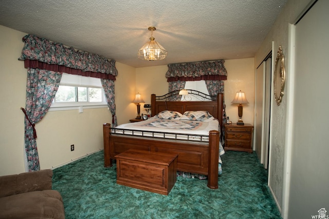 bedroom with dark carpet and a textured ceiling