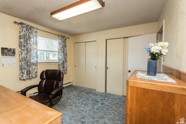 carpeted home office featuring baseboard heating and a textured ceiling