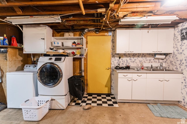 unfinished basement with washer and clothes dryer and a sink