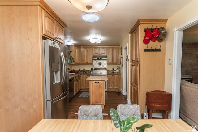 kitchen with under cabinet range hood, a kitchen island, wood counters, appliances with stainless steel finishes, and dark wood-style floors