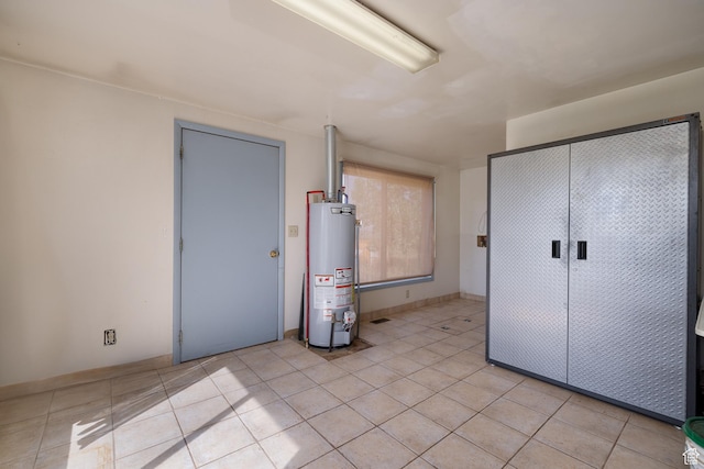 interior space with water heater and light tile patterned flooring